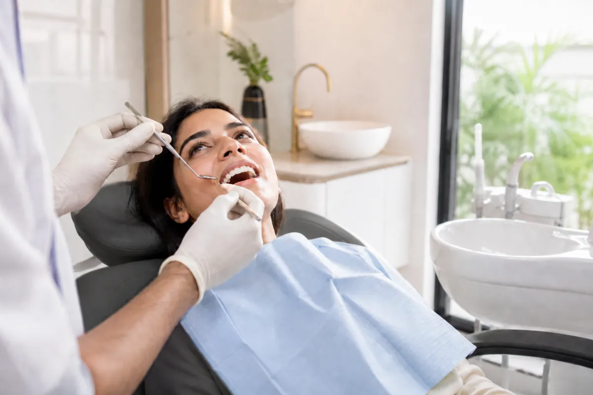Patient lying on a dental chair during a checkup at a clinic in Moshi.